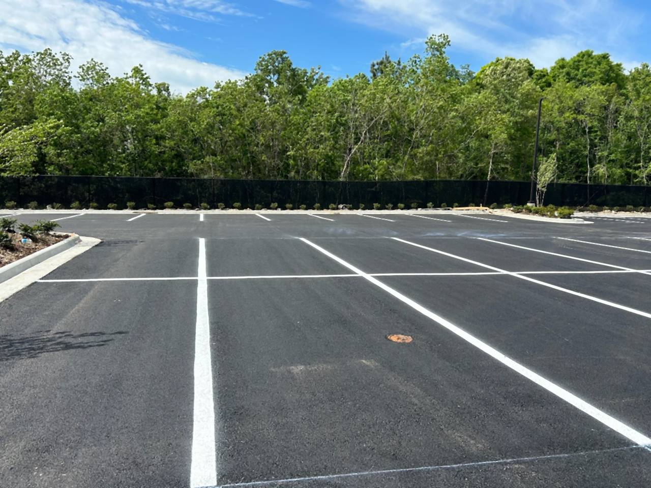 Newly paved and striped parking lot at the Caliber Collision new construction project in Denham Springs, Louisiana.